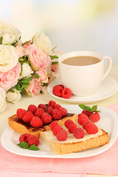 Delicious toast with raspberries on table on light background — Stock Photo, Image