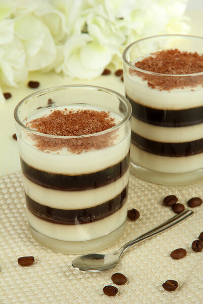 Tasty jelly coffee with milk on table on light background