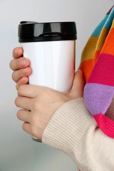 Hot drink in plastic glass in hands on bright background — Stock Photo, Image