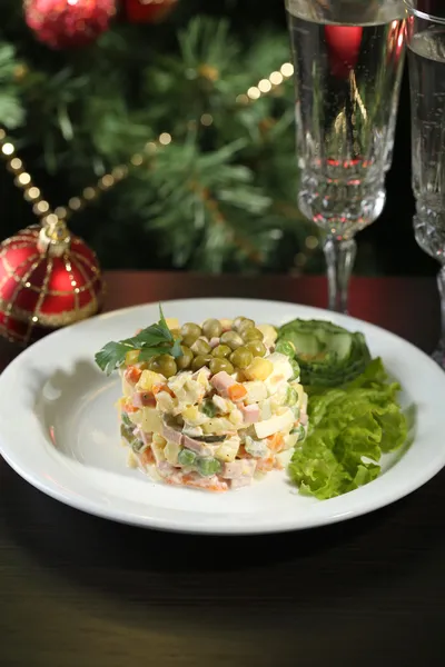 Russian traditional salad Olivier, on wooden table, on bright background — Stock Photo, Image