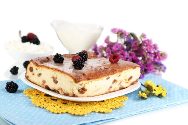 Cheese casserole with raisins on plate on napkin isolated on white — Stock Photo, Image