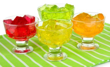 Tasty jelly cubes in bowls on table on white background clipart