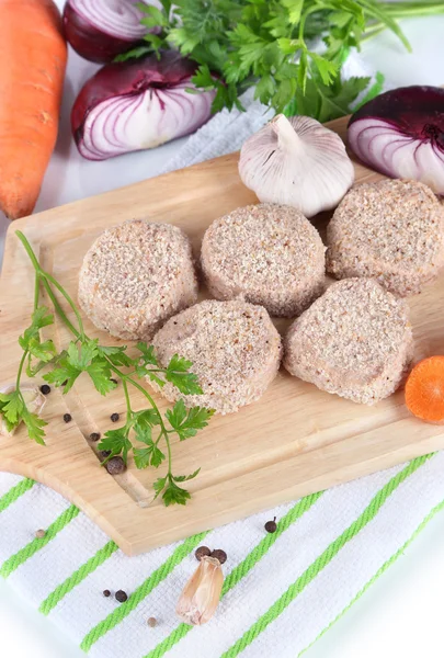 Meat patties on board on napkin isolated on white — Stock Photo, Image