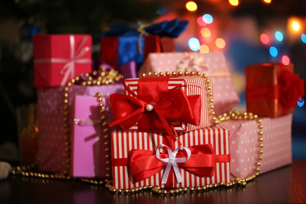 Many gifts on bright background — Stock Photo, Image