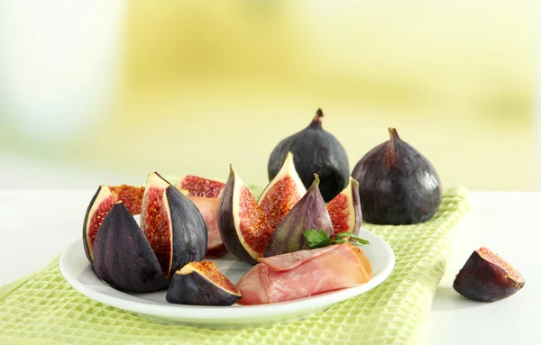 Tasty figs with ham on white wooden table — Stock Photo, Image