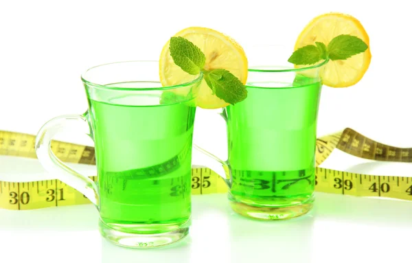 Two transparent cups of green tea and measuring tape close up — Stock Photo, Image