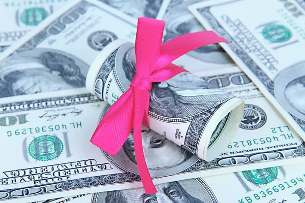 Dollars with gift bow close-up — Stock Photo, Image