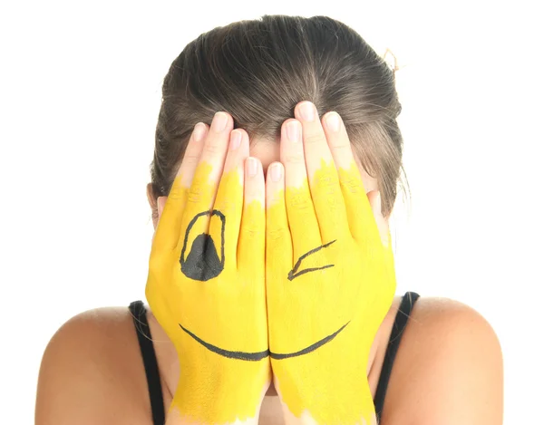 Retrato de chica escondiendo su cara bajo máscara de sonrisa aislada en blanco — Foto de Stock