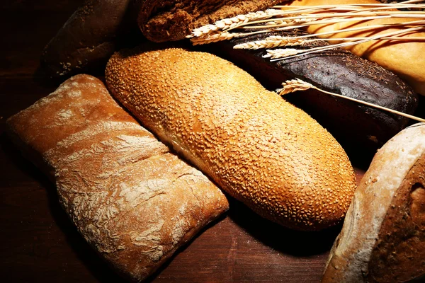Much bread on wooden board — Stock Photo, Image
