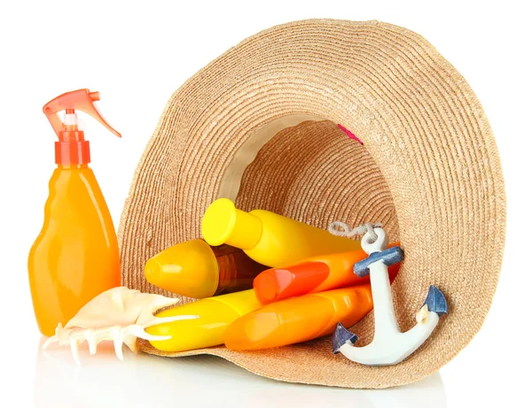 Bottles with suntan cream in hat isolated on white — Stock Photo, Image