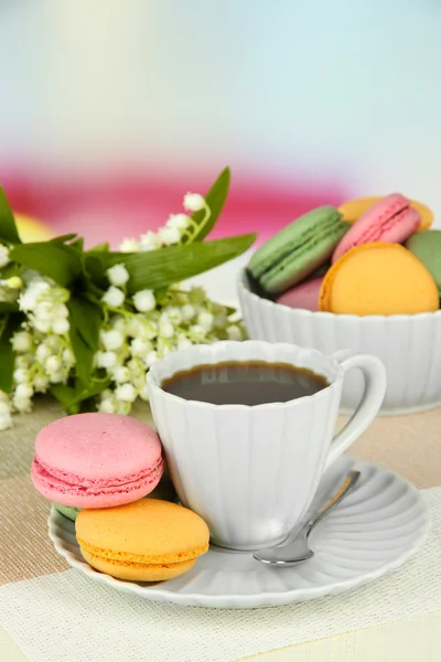 Coffee and macaroons on table on light background — Stock Photo, Image