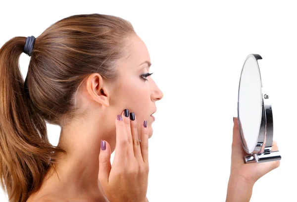 Vacker flicka preens innan liten spegel isolerad på vit — Stockfoto