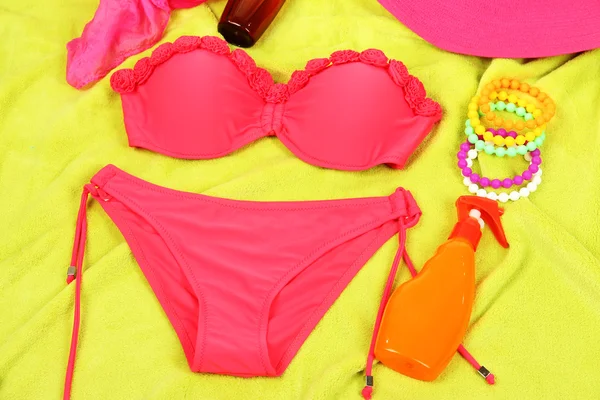 Swimsuit and beach items on bright background — Stock Photo, Image