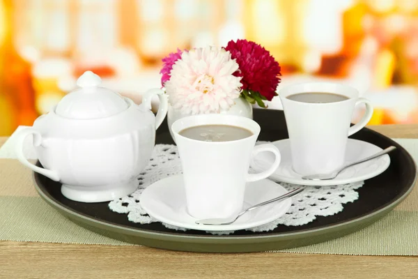 Cups of coffee on tray on table in cafe — Stock Photo, Image