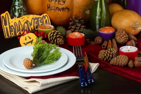 Table setting for Halloween with pumpkin and candles close-up — Stock Photo, Image