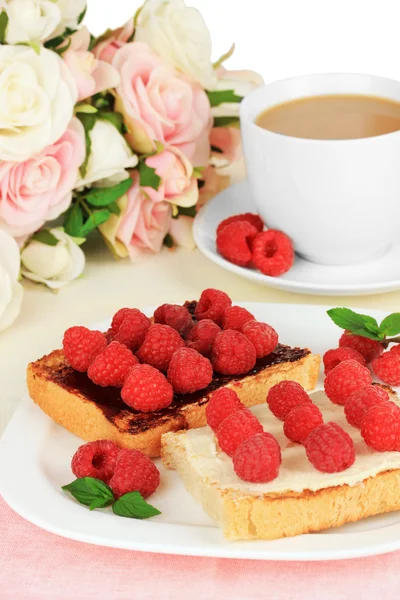 Delicious toast with raspberries on table on light background — Stock Photo, Image