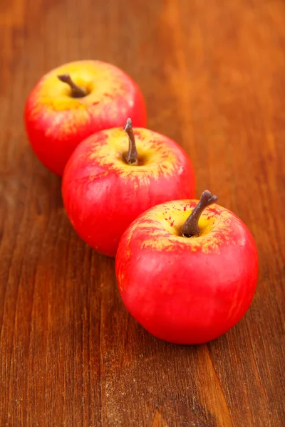 Small apples on wooden background — Stock Photo, Image