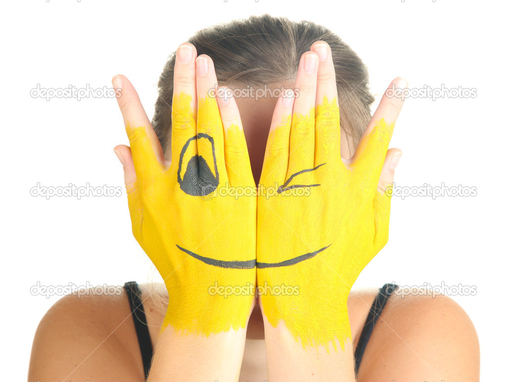 Portrait of girl hiding her face under smile mask isolated on white