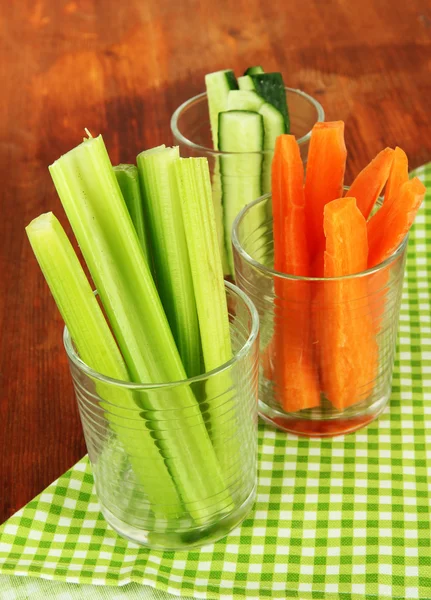 Fresh green celery with vegetables in glasses on table close-up — Stock Photo, Image