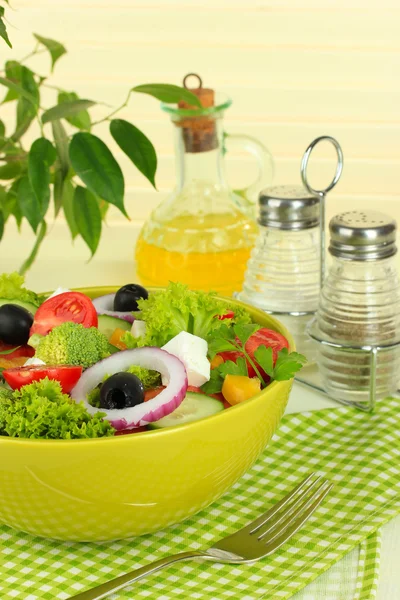 Greek salad on plate on table on light background — Stock Photo, Image