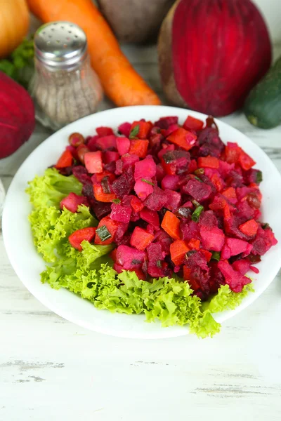 Beet salad on plate on wooden table — Stock Photo, Image