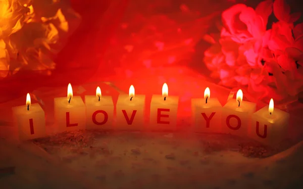 Candles with printed sign I LOVE YOU,on color fabric background — Stock Photo, Image