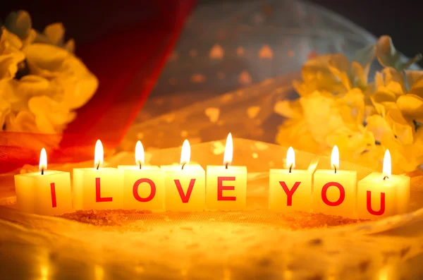 Candles with printed sign I LOVE YOU,on bright background — Stock Photo, Image