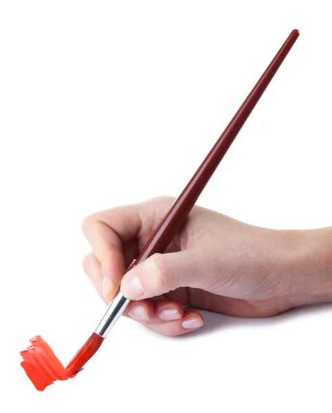 Hand holding brush with red paint isolated on white — Stock Photo, Image