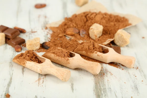 Cocoa powder on wooden table — Stock Photo, Image