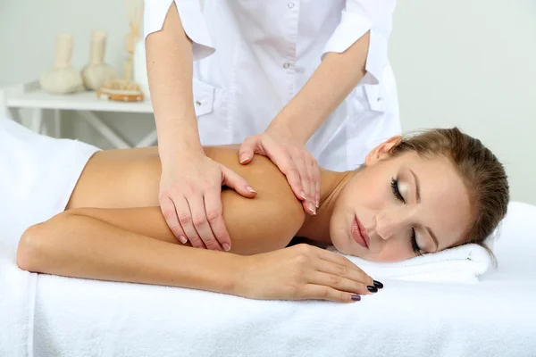 Beautiful young woman having back massage close up — Stock Photo, Image