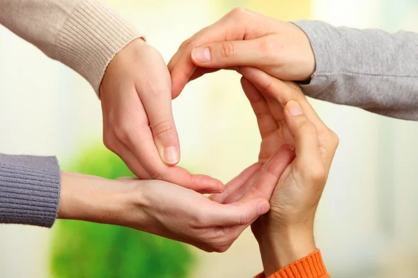 Human hands making circle on bright background