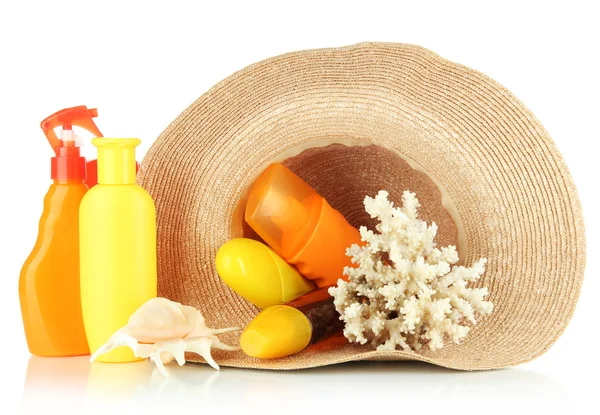 Bottles with suntan cream in hat isolated on white — Stock Photo, Image