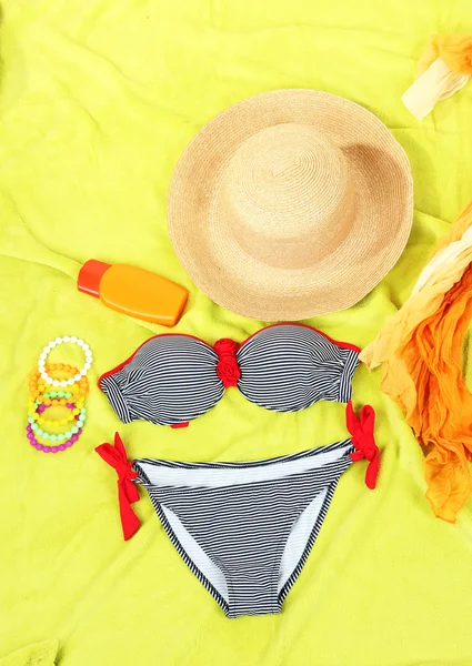 Swimsuit and beach items on bright background — Stock Photo, Image