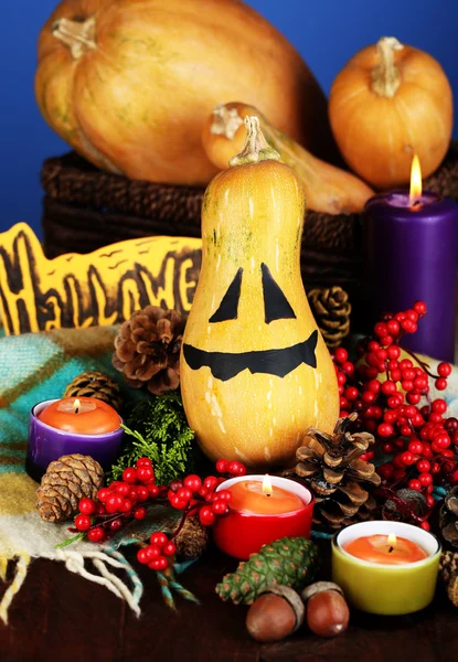 Composition for Halloween with pumpkins and candles on color background — Stock Photo, Image