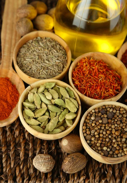 Many different spices and fragrant herbs on braided table close-up — Stock Photo, Image