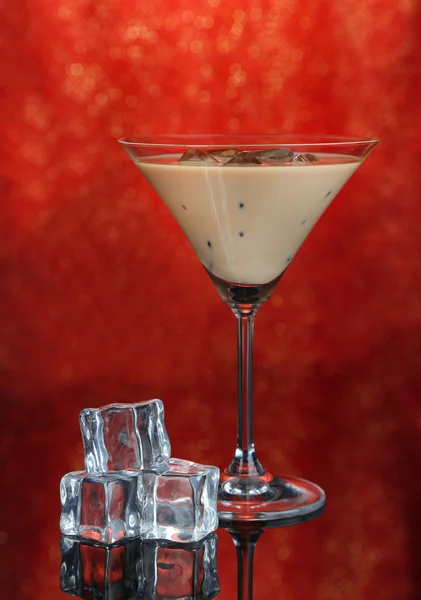 Baileys liqueur in glass on red background — Stock Photo, Image