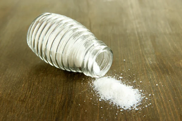 Glass saltcellar with salt on wooden background — Stock Photo, Image