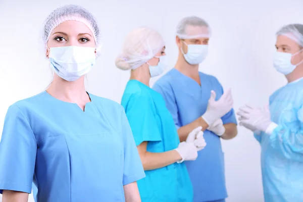 Surgeons standing on grey background — Stock Photo, Image