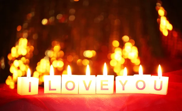 Candles with printed sign I LOVE YOU,on blur lights background — Stock Photo, Image