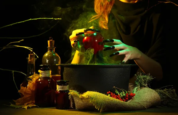 Witch in scary Halloween laboratory on dark color background — Stock Photo, Image