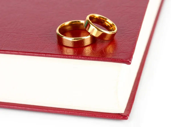 Wedding rings on bible isolated on white — Stock Photo, Image