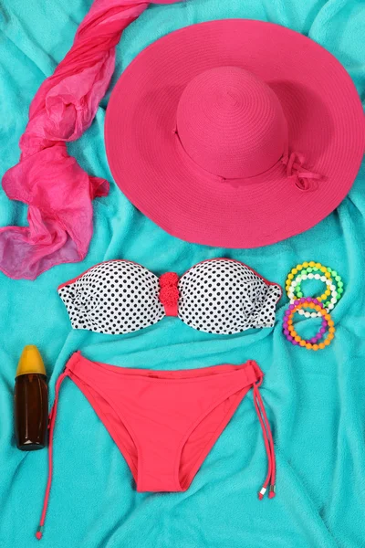 Swimsuit and beach items on bright blue background — Stock Photo, Image