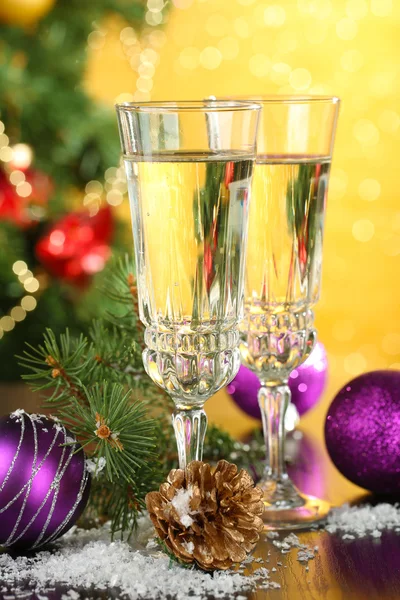 Composition with Christmas decorations and two champagne glasses, on bright background — Stock Photo, Image