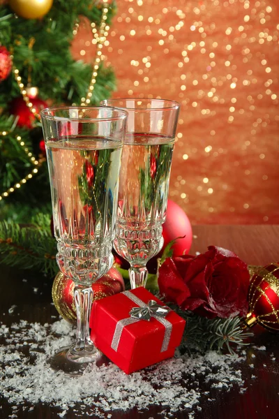 Composition with Christmas decorations and two champagne glasses, on bright background — Stock Photo, Image