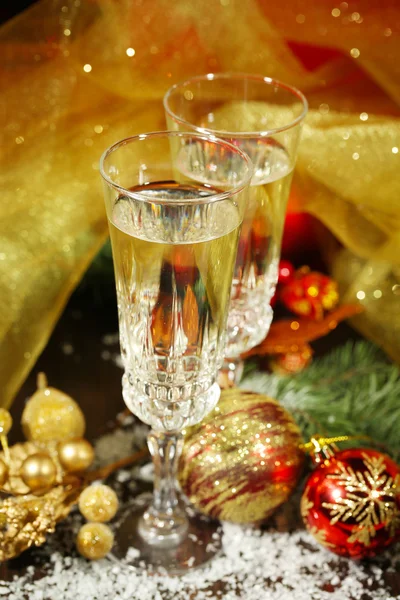 Composition with Christmas decorations and two champagne glasses, on bright background — Stock Photo, Image