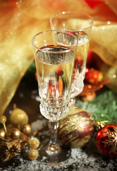 Composition with Christmas decorations and two champagne glasses, on bright background — Stock Photo, Image