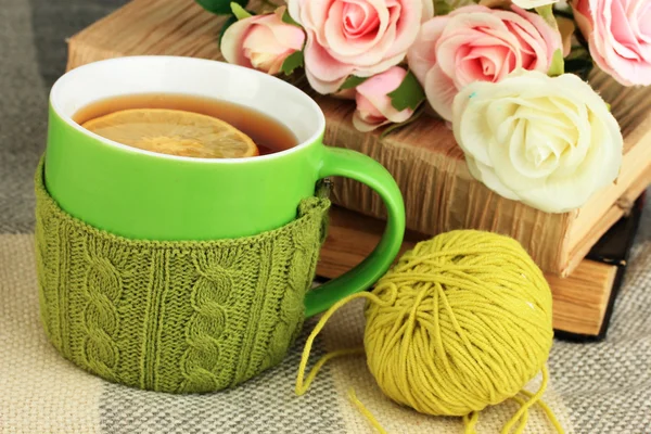 Cup of tea with knitted thing on it close up — Stock Photo, Image