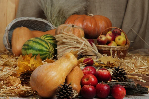 Fruits and vegetables with baskets on straw close up