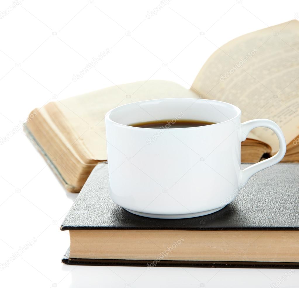 Cup of coffee and books isolated on white