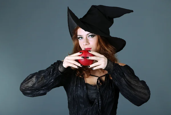 Halloween witch with broom on gray background — Stock Photo, Image